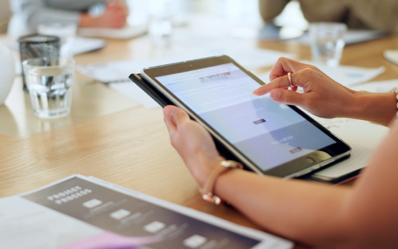 A woman checks in on surveillance at her business via a remote app.